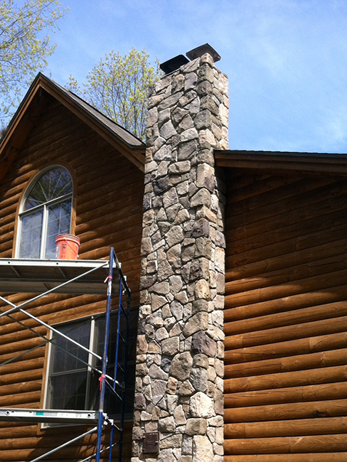 Stone venner installed on a chimney in Goffstown NH by New England Accents